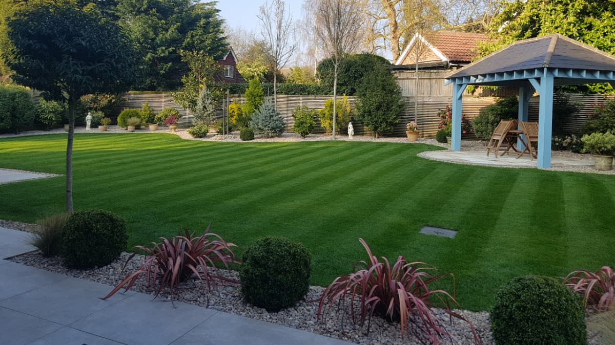 A neat striped lawn, cared for and green.